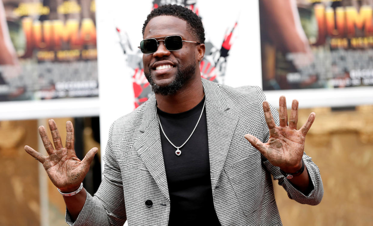 Actor Kevin Hart shows his hands after placing them in cement at a ceremony in the forecourt of the TCL Chinese theatre in Los Angeles, California, U.S., December 10, 2019. REUTERS/Mario Anzuoni