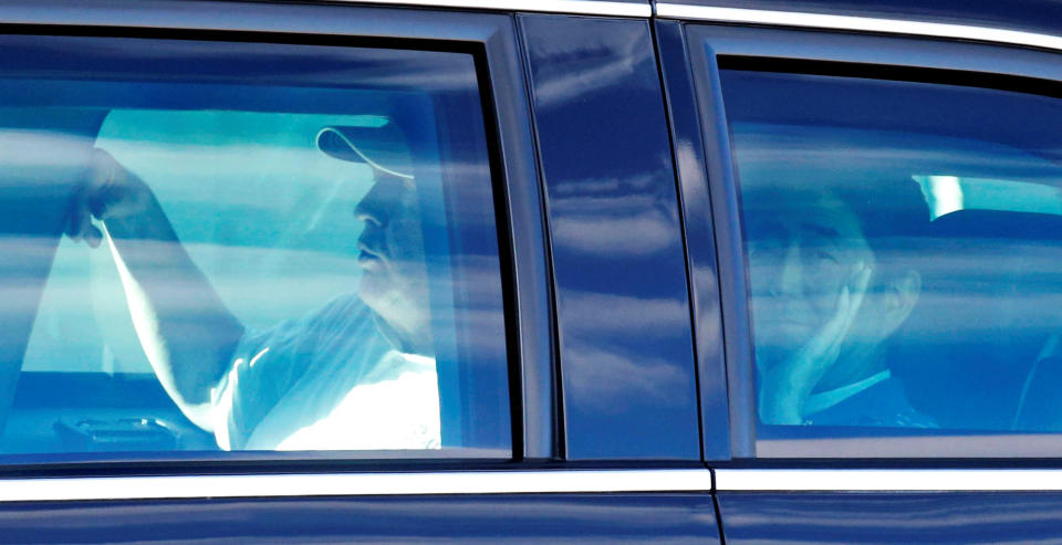 Japanese Prime Minister Shinzo Abe (R) and U.S. President Donald Trump are seen in the Presidential Limousine as they depart from Trump International Golf club in West Palm Beach, Florida, U.S., February 11, 2017, in this photo taken by Kyodo.
