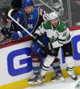 Dallas Stars center Joe Pavelski, right, checks Colorado Avalanche right wing Mikko Rantanen during the first period of Game 6 of an NHL hockey playoff series Friday, May 17, 2024, in Denver. (AP Photo/David Zalubowski)