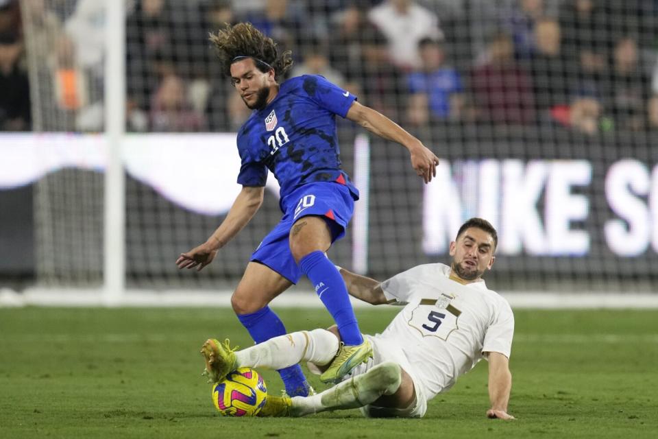 United States forward Cade Cowell and Serbia defender Marko Mijailovic get tangled up.