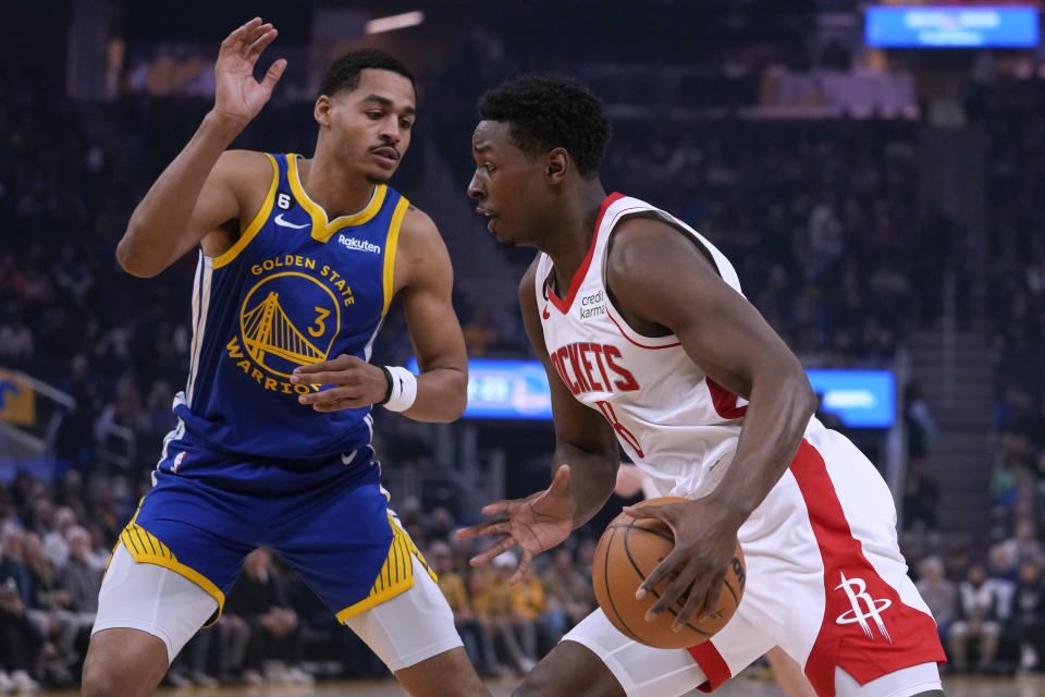 Houston Rockets guard Jae'Sean Tate, right, drives to the basket while defended by Golden State Warriors guard Jordan Poole during the first half of an NBA basketball game in San Francisco, Friday, Feb. 24, 2023. (AP Photo/Godofredo A. Vásquez)