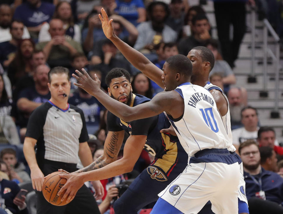 New Orleans Pelicans forward Anthony Davis looks to pass the ball past Dallas Mavericks forward Dorian Finney-Smith (10) during the first half of an NBA basketball game in New Orleans, Friday, Dec. 28, 2018. (AP Photo/Gerald Herbert)