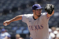 Texas Rangers starting pitcher Dane Dunning throws during the first inning of a baseball game against the Kansas City Royals Wednesday, June 29, 2022, in Kansas City, Mo. (AP Photo/Charlie Riedel)