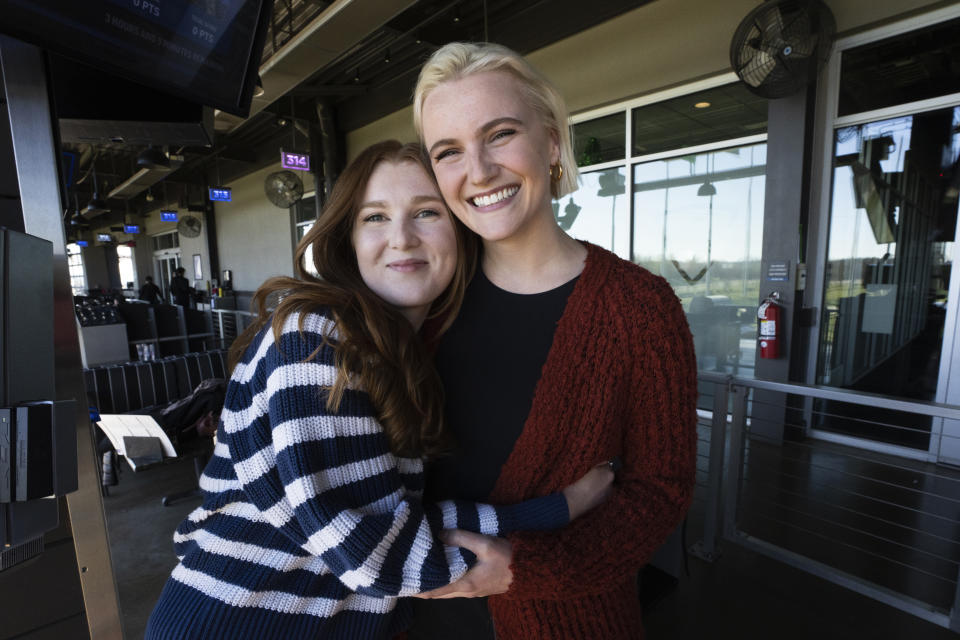 Calista Anderson greets a student during a gathering for the current CIA Officers Memorial Foundation scholarship recipients Saturday, Nov. 26, 2022, in Ashburn, Va. The foundation recently hired Anderson, the daughter of one of seven officers to die in a December 2009 attack on the CIA's base in Khost, Afghanistan. Anderson wants to help other children of fallen officers and shares her memories of her mother, Jennifer Matthews. (AP Photo/Manuel Balce Ceneta)