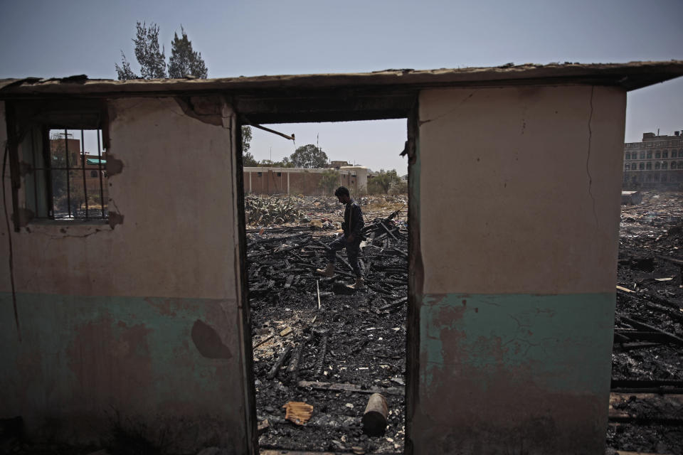 FILE - A Yemeni soldier inspects a site of Saudi-led airstrikes targeting two houses in Sanaa, Yemen, March 26, 2022. A new report says there’s no sign that the Pentagon or State Department has ever investigated whether U.S. military aid was used in Saudi or Emirati strikes alleged to have killed civilians in Yemen. The General Accounting Office released the report Wednesday. (AP Photo/Hani Mohammed, File)