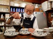 Shizuo Mori, the owner of Heckeln coffee shop brews coffee with a Syphon coffee maker at his shop in Tokyo