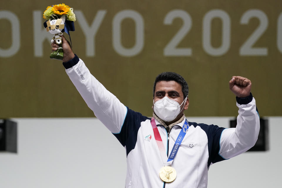 Javad Foroughi, of Iran, celebrates after winning the gold medal in the men's 10-meter air pistol at the Asaka Shooting Range in the 2020 Summer Olympics, Saturday, July 24, 2021, in Tokyo, Japan. (AP Photo/Alex Brandon)