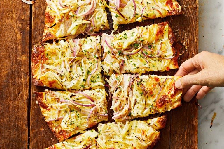 <p>This easy appetizer can feed a whole crowd. It has yellow onion, red onion, and fennel for tons of flavor. </p><p>Get the <strong><a href="https://www.goodhousekeeping.com/food-recipes/a38539020/onion-flatbread-recipe/" rel="nofollow noopener" target="_blank" data-ylk="slk:Onion Flatbread recipe;elm:context_link;itc:0;sec:content-canvas" class="link ">Onion Flatbread recipe</a></strong>. </p>