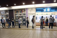 People wearing face masks to protect against the spread of the new coronavirus keep social distancing as they wait to buy sushi in Yokohama, near Tokyo, Thursday, May 28, 2020. Japanese Prime Minister Shinzo Abe lifted a coronavirus state of emergency on Monday, ending the restrictions nationwide as businesses begin to reopen. (AP Photo/Koji Sasahara)