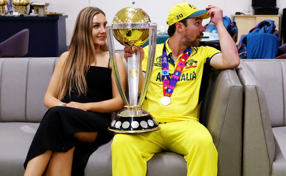 Travis Head and wife Jessica, pictured here with the Cricket World Cup trophy. 