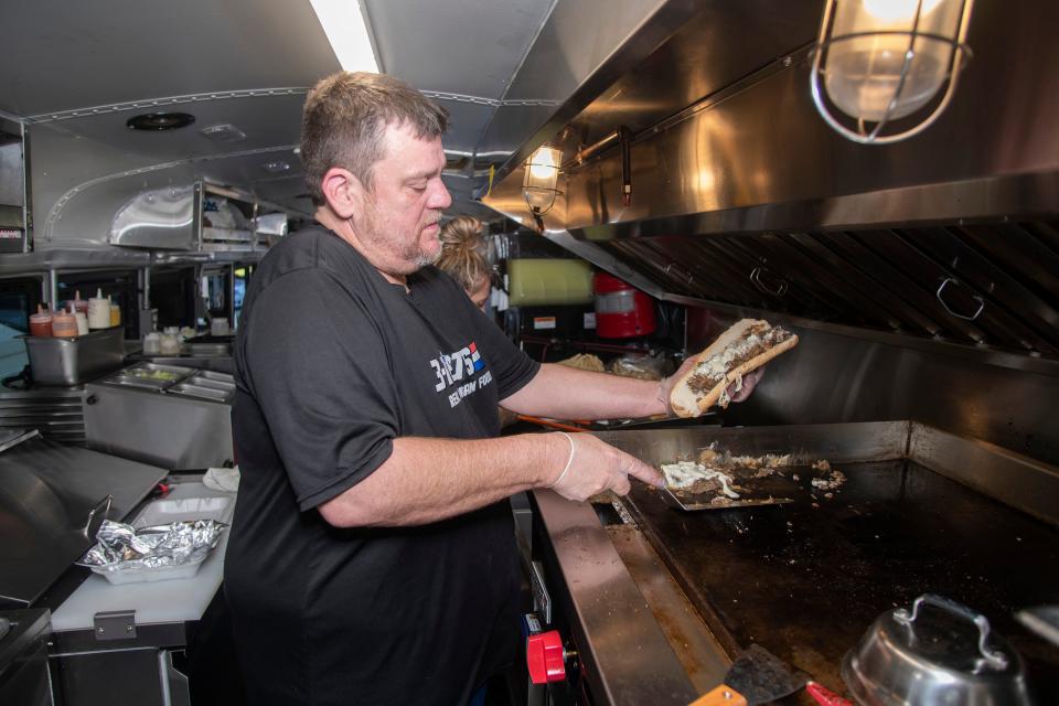 Sean DeSmet, the owner of 3-D Eats & Tea food truck, prepares one of his signature cheese steak sandwiches for a customer on Friday, Oct. 7, 2022