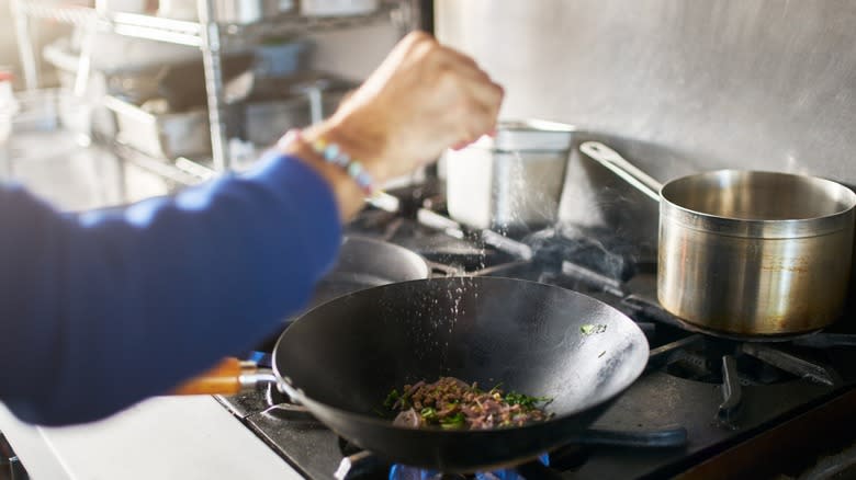 Seasoning food in wok