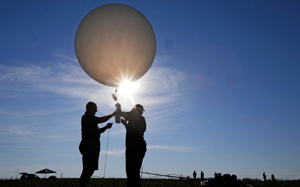 People prepare to send up weather balloons - AP