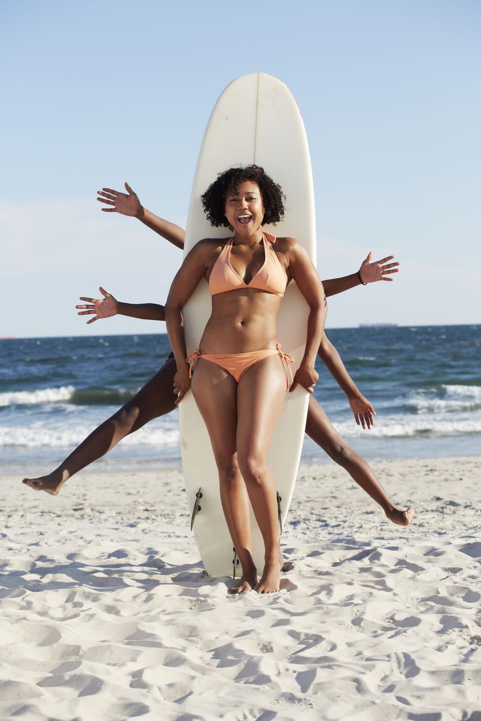 summer activities friends posing with surfboard on beach