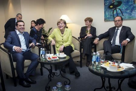 German Chancellor Angela Merkel and French President Francois Hollande (R) attend a meeting with Greek Prime Minister Alexis Tsipras (L) in Riga, May 21, 2015. REUTERS/Guido Bergmann/Bundesregierung (BPA)/Handout via Reuters