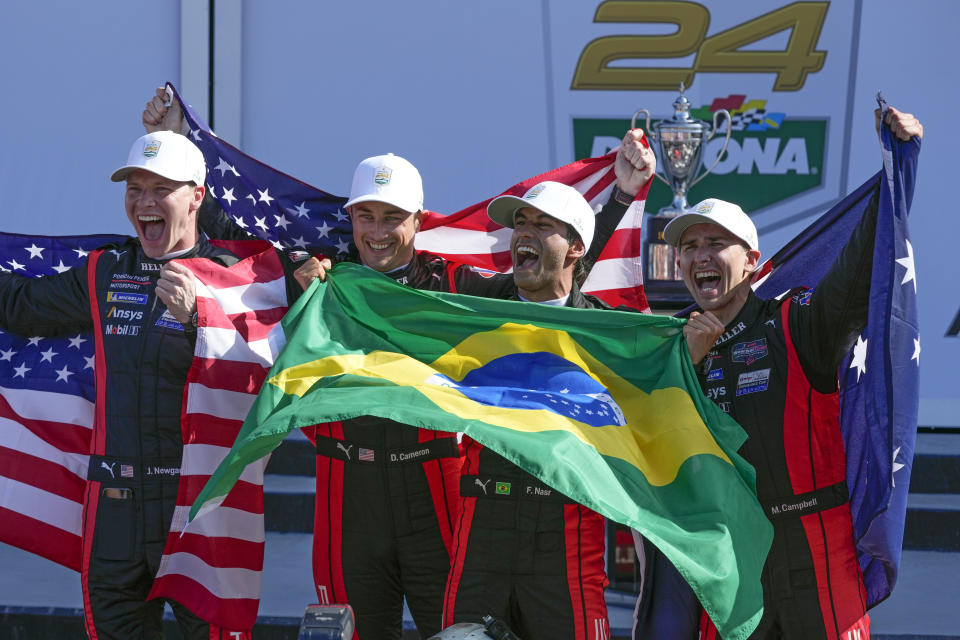 Porsche Penske Motorsport team drivers, from left, Josef Newgarden, Dane Cameron, Felipe Nasr, of Brazil, and Matt Campbell, of Australia, celebrate in Victory Lane after winning the Rolex 24-hour auto race at Daytona International Speedway, Sunday, Jan. 28, 2024, in Daytona Beach, Fla. (AP Photo/John Raoux)