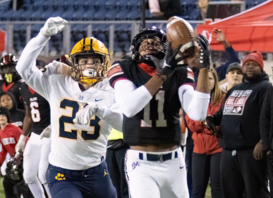 McKinley’s Keith Quincy makes a reception in front of St. Ignatius’s Max Woidke for a touchdown to give McKinley a 21-3 lead Friday, Nov. 3, 2023.