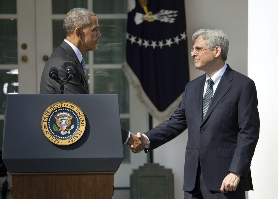 Two men shake hands