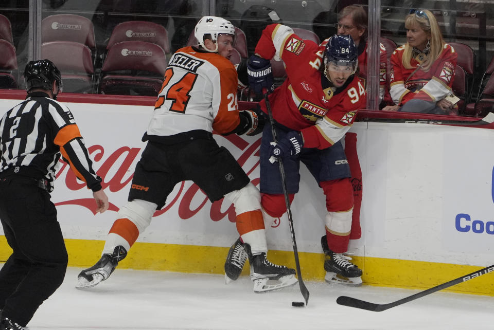Florida Panthers left wing Ryan Lomberg (94) and Philadelphia Flyers defenseman Nick Seeler (24) go after the puck during the first period of an NHL hockey game, Tuesday, Feb. 6, 2024, in Sunrise, Fla. (AP Photo/Marta Lavandier)