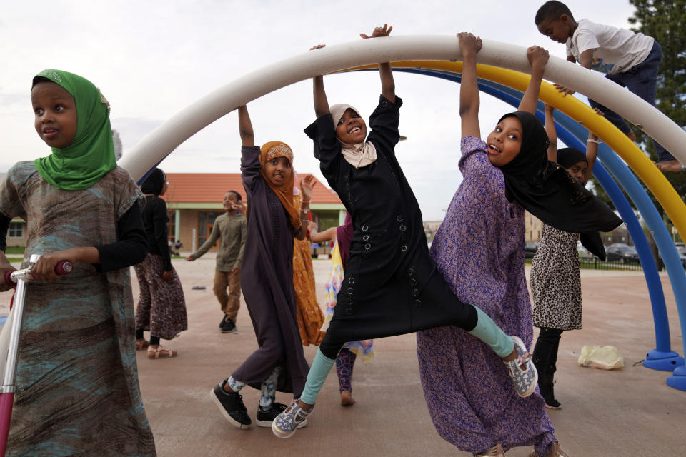 Children play at a park in the predominantly Somali neighborhood of Cedar-Riverside in Minneapolis on Thursday, May 12, 2022. Dar Al-Hijrah, the local mosque, is one of 12 in Minneapolis that have been approved to publicly broadcast the Islamic call to prayer, or adhan, three times a day. (AP Photo/Jessie Wardarski)
