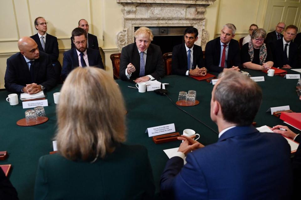 Mr Johnson was flanked by Cabinet Secretary Simon Case to his right and Chancellor Rishi Sunak (POOL/AFP via Getty Images)