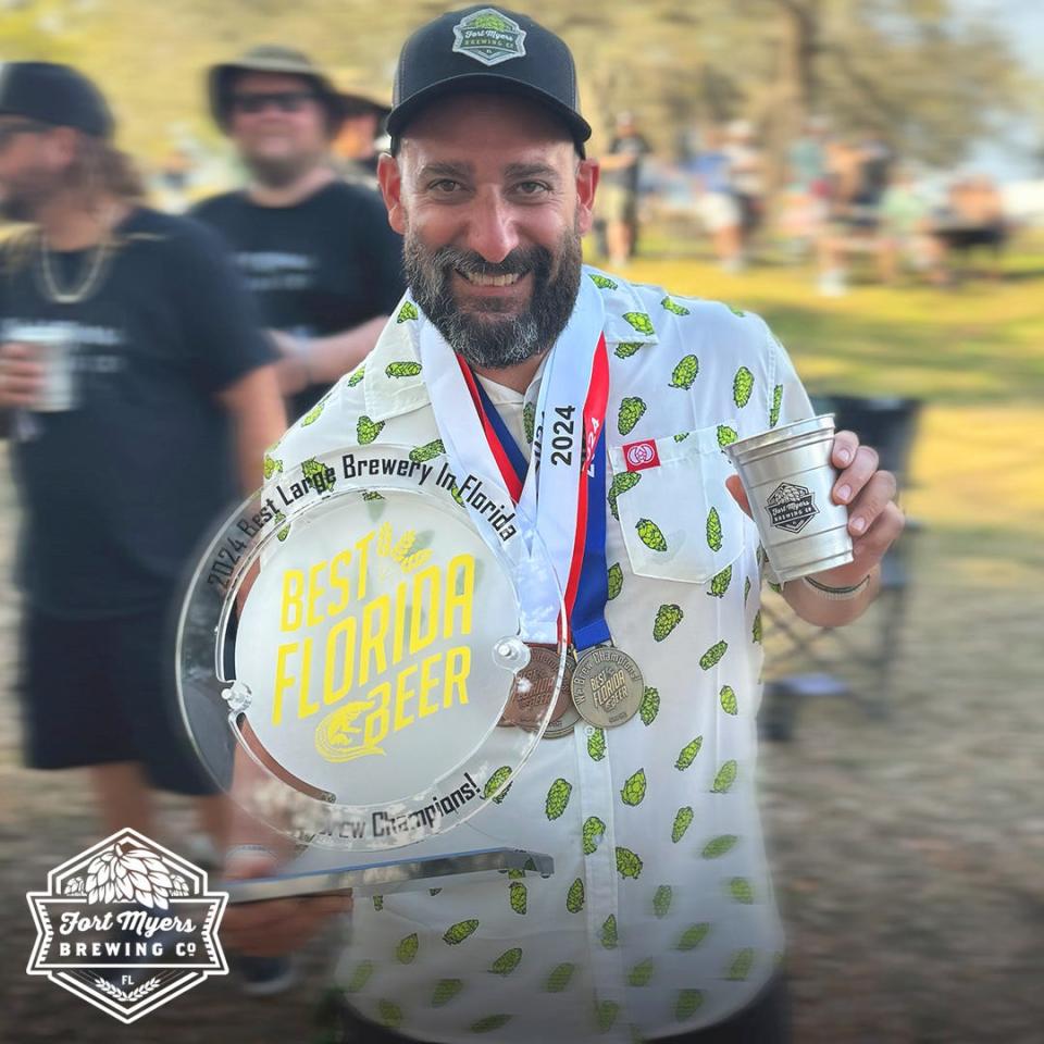 Head brewer Anthony Coronato displays the awards and medals won by Fort Myers Brewing at the 2024 Brewer's Ball in Tampa.