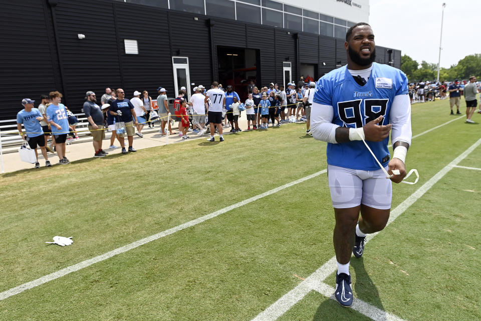 Tennessee Titans defensive tackle Jeffery Simmons (98) walks of the field after signing autographs for fans after practice at the NFL football team's training camp, Saturday, July 29, 2023, in Nashville, Tenn. (AP Photo/Mark Zaleski)