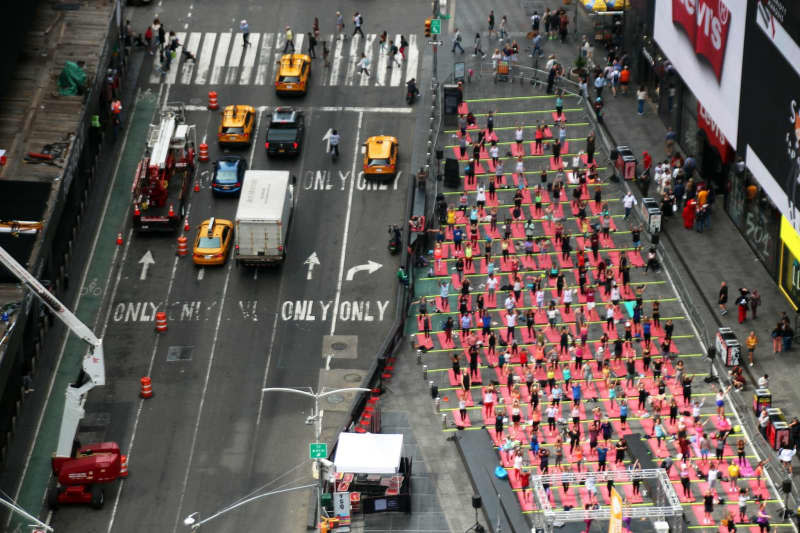 Hundreds of people practise mass yoga every year in Times Square to mark World Yoga Day. Christina Horsten/dpa