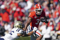 Georgia running back Zamir White (3) breaks free from Charleston Southern defensive back Trayson Fowler (36) in the first half of an NCAA college football game Saturday, Nov. 20, 2021, in Athens, Ga. (AP Photo/John Bazemore)