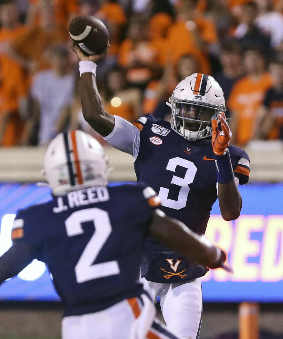 Virginia quarterback Bryce Perkins (3) throws a pass to Virginia wide receiver Joe Reed (2) during the second quarter of an NCAA college football game against Old Dominion in Charlottesville, Va., Saturday, Sept. 21, 2019. (AP Photo/Andrew Shurtleff)