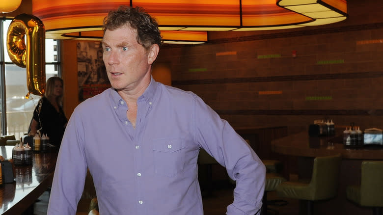 Bobby Flay stressed in purple shirt