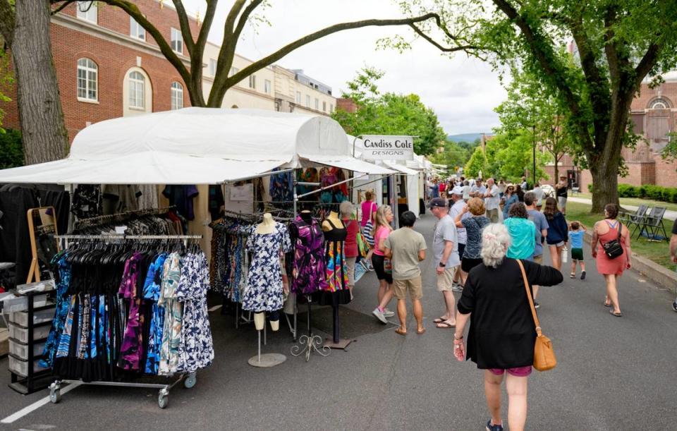 Visitors browse the artist booths along Burrowes Street at the Central Pennsylvania Festival of the Arts on Thursday, July 11, 2024.