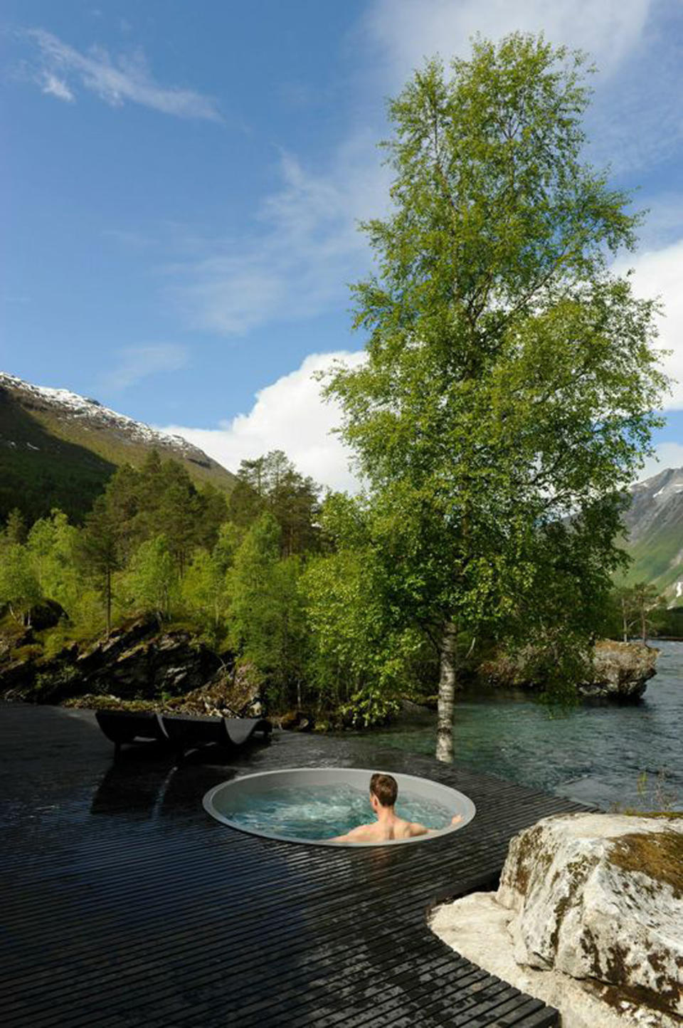 Guests at Juvet Landscape Hotel enjoy a hot tub surrounded by nature. (Andrea Kitay/Tribune News Service via Getty Images)