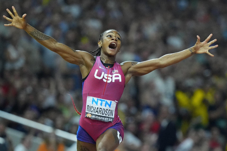 Sha'Carri Richardson, of the United States, celebrates after winning the gold medal in the final of the Women's 100-meters during the World Athletics Championships in Budapest, Hungary, Monday, Aug. 21, 2023. (AP Photo/Petr David Josek)