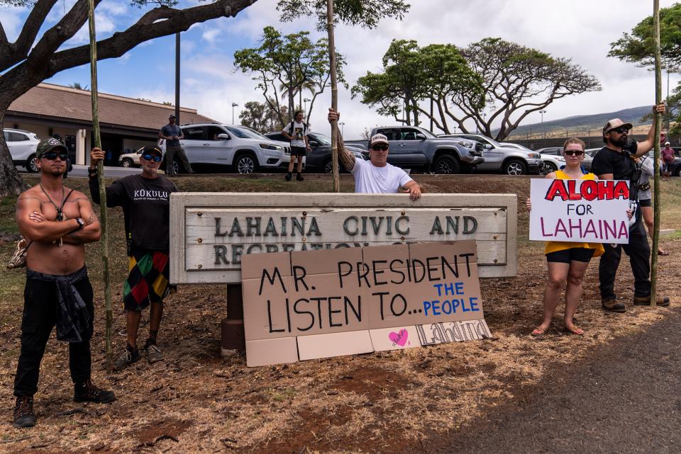 People wait for the arrival of President Joe Biden outside the Lahaina Civic Center in Lahaina, Hawaii, Monday, Aug. 21, 2023. (AP Photo/Jae C. Hong) ORG XMIT: HIJH109