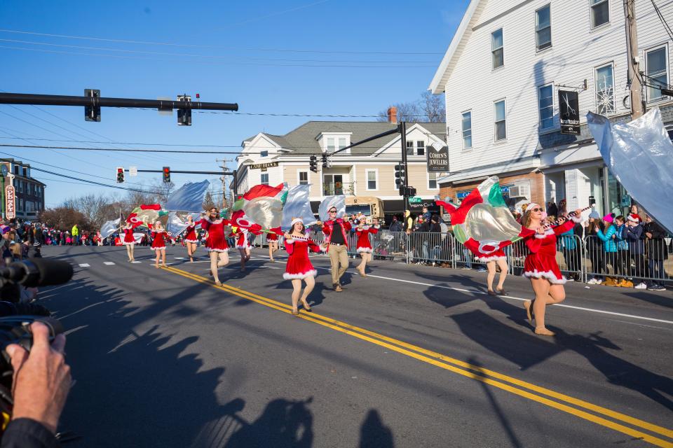 Members of the UNH Winter Guard march in the Hampton Holiday Parade.