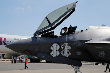 FILE PHOTO: A U.S. soldier adjusts his cap in the cockpit as a Lockheed Martin F-35 Lightning II aircraft is moved on the eve of the 52nd Paris Air Show at Le Bourget Airport near Paris, France June 18, 2017. REUTERS/Pascal Rossignol/File Photo