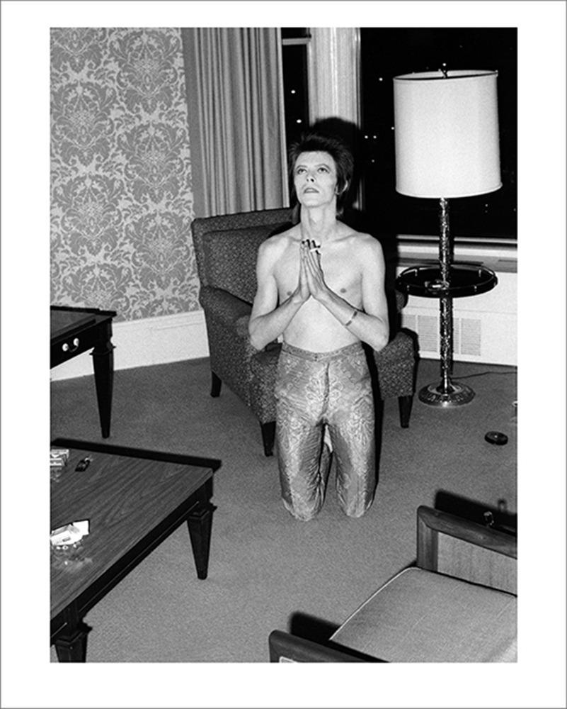 David Bowie praying on his knees, Chicago, 1973. 