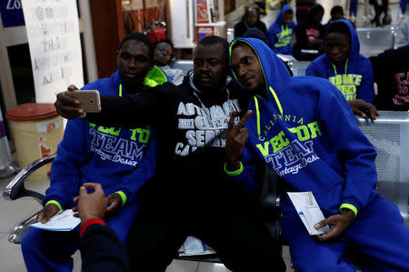 Guinean migrants take a selfie at the airport before they are deported to Guinea, in Misrata, Libya, December 27, 2017. REUTERS/Ismail Zitouny