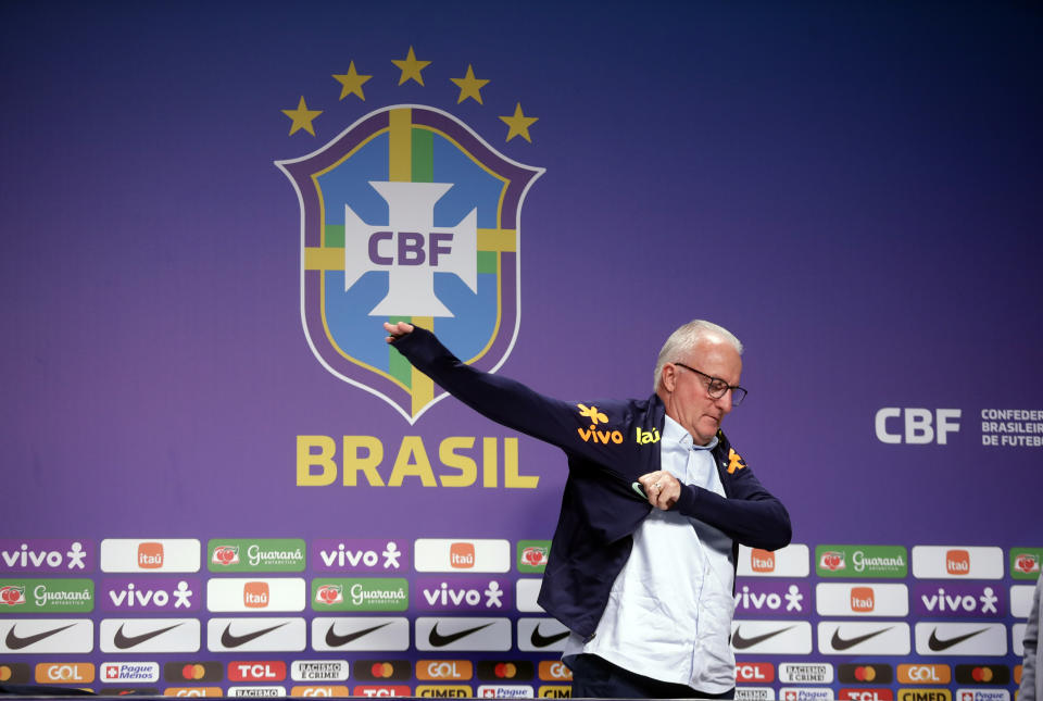 Dorival Junior, the new head coach of the Brazilian national soccer team, puts on a Brazil jacket during a press conference in Rio de Janeiro, Brazil, Thursday, Jan. 11, 2024. (AP Photo/Bruna Prado)