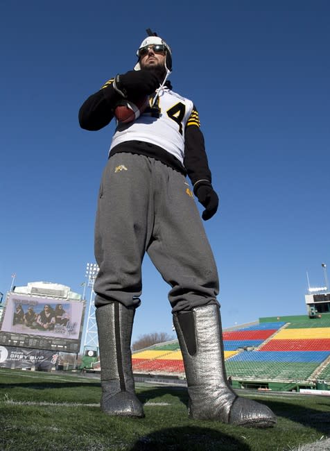 Hamilton Tiger-Cats punter Josh Bartel poses in his silver boot liners on the field during team practice in Regina, Sask. on Saturday November23, 2013. THE CANADIAN PRESS/Frank Gunn