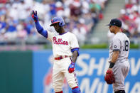 Philadelphia Phillies' Andrew McCutchen, left, reacts past New York Yankees second baseman Rougned Odor after hitting a double off pitcher Domingo German during the second inning of a baseball game, Sunday, June 13, 2021, in Philadelphia. (AP Photo/Matt Slocum)