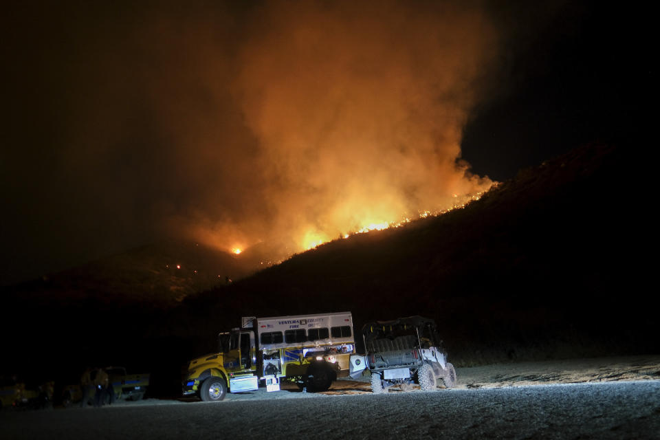 Fire vehicles are seen as a wildfire burns on a hillside Tuesday, Sept. 6, 2022, near Hemet, Calif. (AP Photo/Ringo H.W. Chiu)