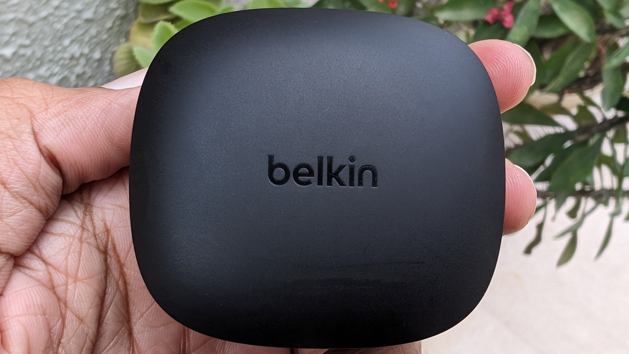  Belkin SoudForm Pulse wireless earbuds held in hand. 