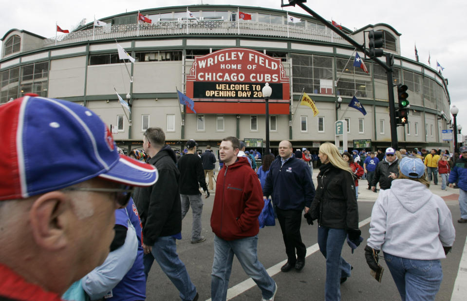 FILE - In this April 7, 2007 file photo, Chicago Cubs fans gather on opening day outside Wrigley Field in Chicago. Chicago’s Wrigley Field, New Orleans’ Saenger Theatre and a historic Los Angeles’ shipbuilding center have joined a list of sites being saved thanks to the efforts of historic preservationists in 2013. (AP Photo/M. Spencer Green, File)