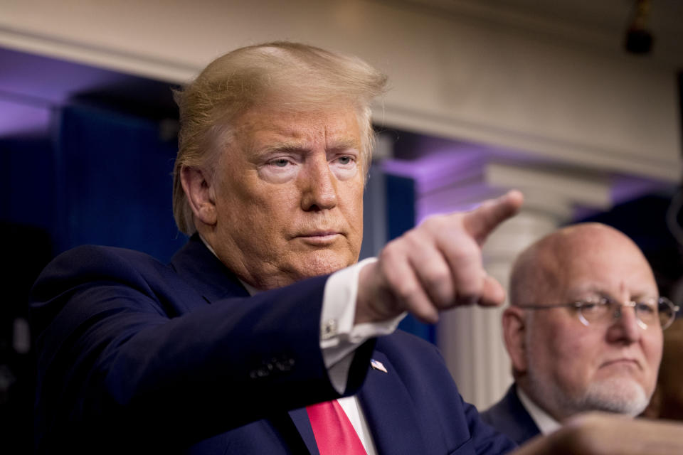 President Donald Trump, accompanied by Robert Redfield, director of the Centers for Disease Control and Prevention, right, takes a question during a news conference on the coronavirus in the press briefing room at the White House, Saturday, Feb. 29, 2020, in Washington. (AP Photo/Andrew Harnik)