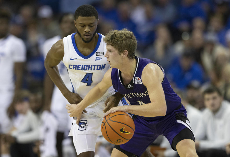 Creighton's Shereef Mitchell, left, guards against Holy Cross' Will Batchelder during the first half of an NCAA college basketball game on Monday, Nov. 14, 2022, in Omaha, Neb. (AP Photo/Rebecca S. Gratz)