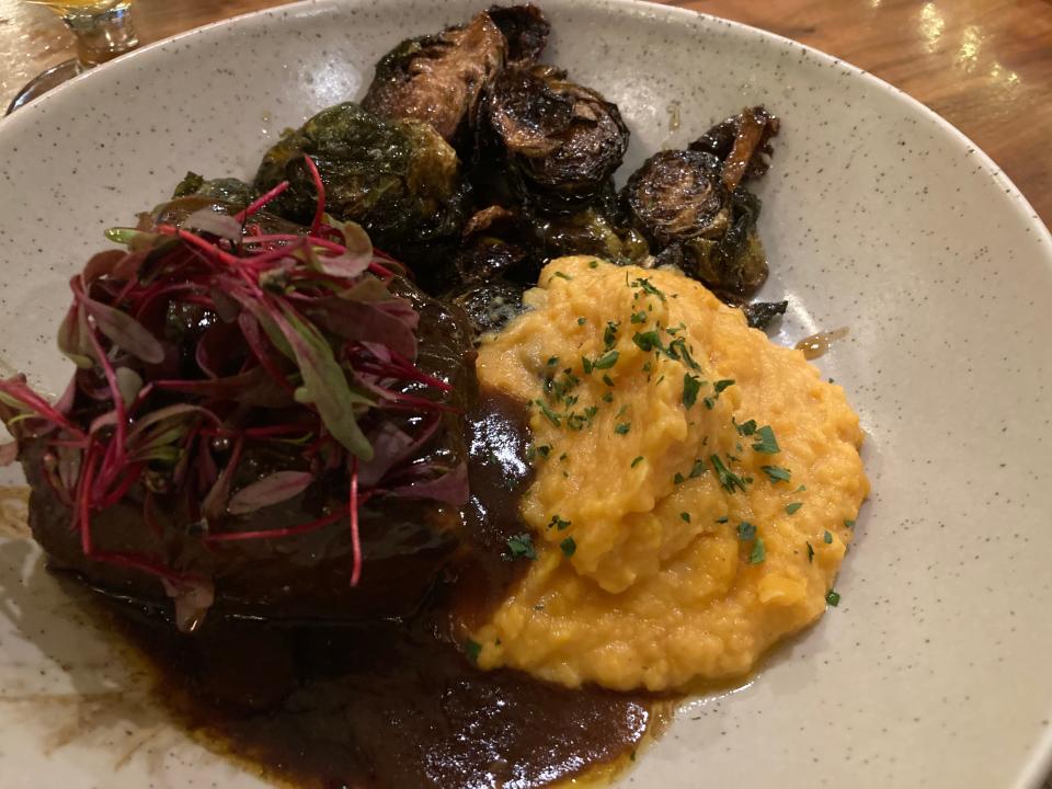 Beer-braised short ribs with sweet potato puree and crispy Brussels sprouts, shown Dec. 20, 2023 at The Kitchen Table in Richmond.