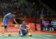 2016 Rio Olympics - Badminton - Mixed Doubles Semifinals - Riocentro - Pavilion 4 - Rio de Janeiro, Brazil - 15/08/2016. Zhang Nan (CHN) of China sits on the court as Zhao Yunlei (CHN) of China touches him on the shoulder during their match against Tontowi Ahmad (INA) of Indonesia and Liliyana Natsir (INA) of Indonesia. REUTERS/Jeremy Lee