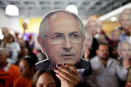 People hold portraits of opposition leader Antonio Ledezma during a news conference at the Venezuelan coalition of opposition parties headquarters in Caracas. REUTERS/Ueslei Marcelino